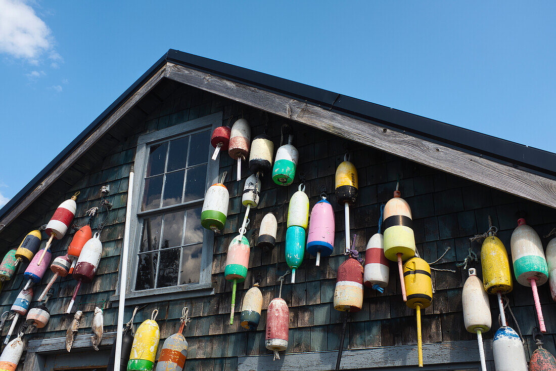 Lobster Trap Buoys hanging on side of Rustic Building