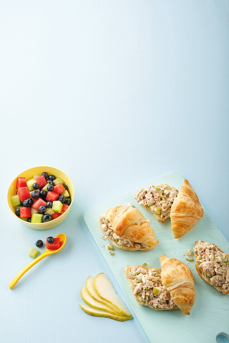 Fruit salad and croissants with chicken salad