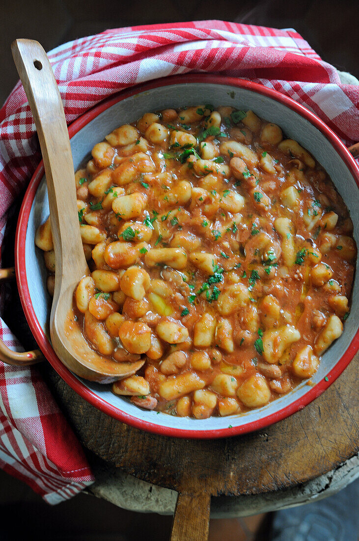 Pisarei- homemade gnocchi in red sauce with beans