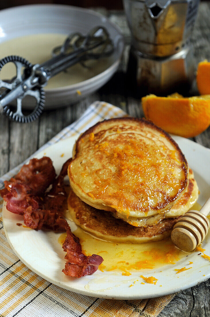 American pancakes with bacon and orange syrup