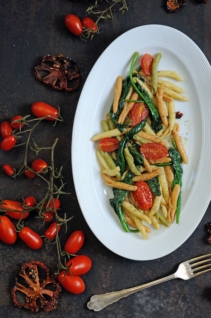 Casarecce pasta with spinach and oven-roasted tomatoes