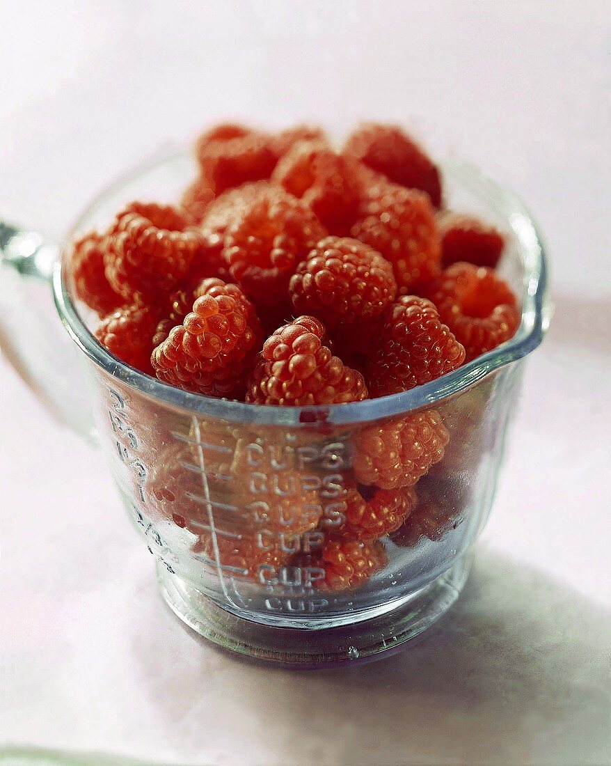 Fresh Raspberries in a Glass Measuring Cup
