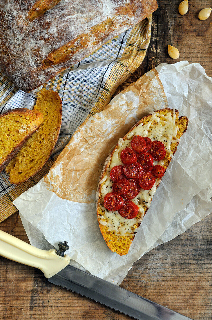 Roasted pumpkin bread with cheese and tomatoes