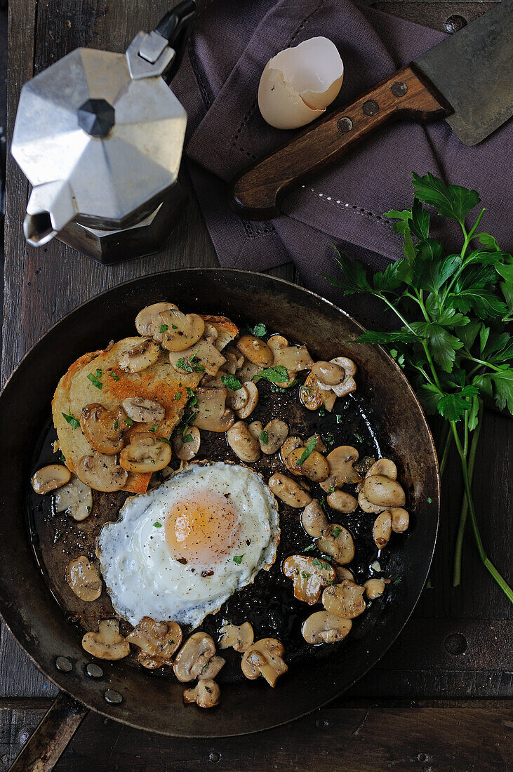 Fried mushrooms with fried egg and bread
