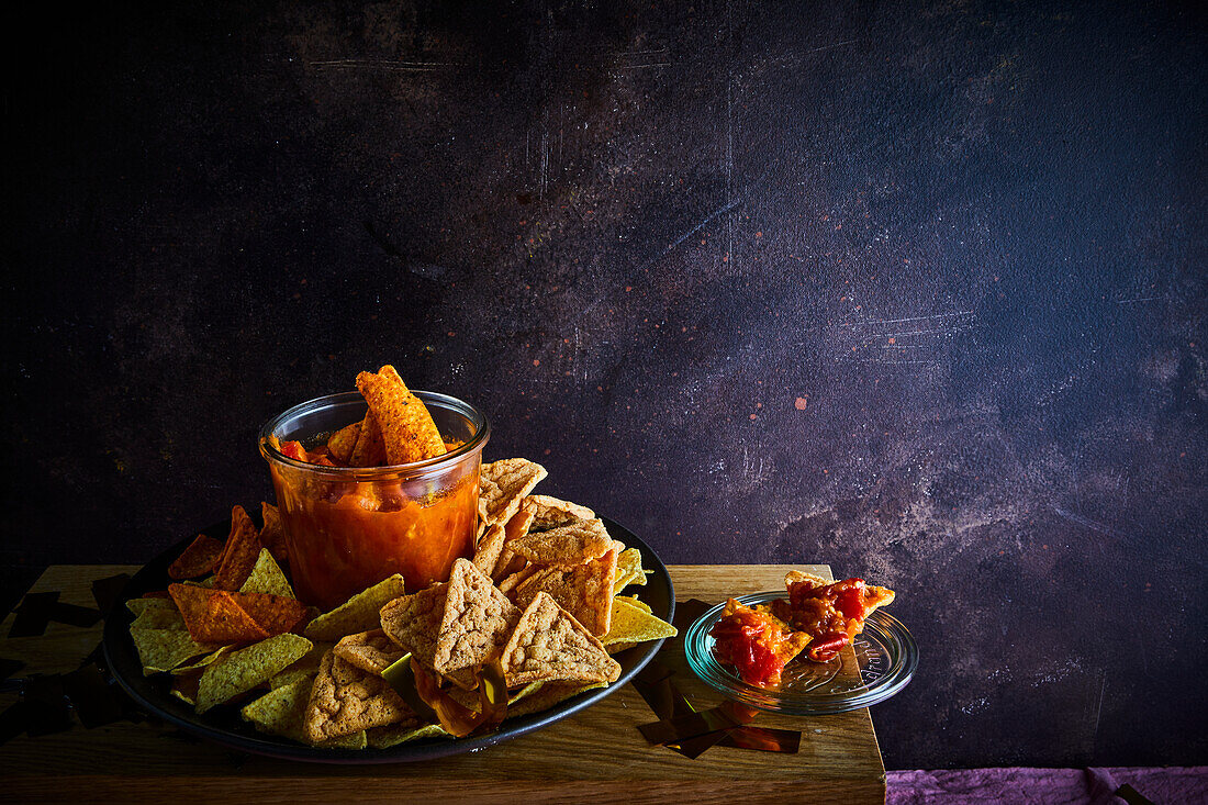 Nachos and tortilla chips with tomato salsa