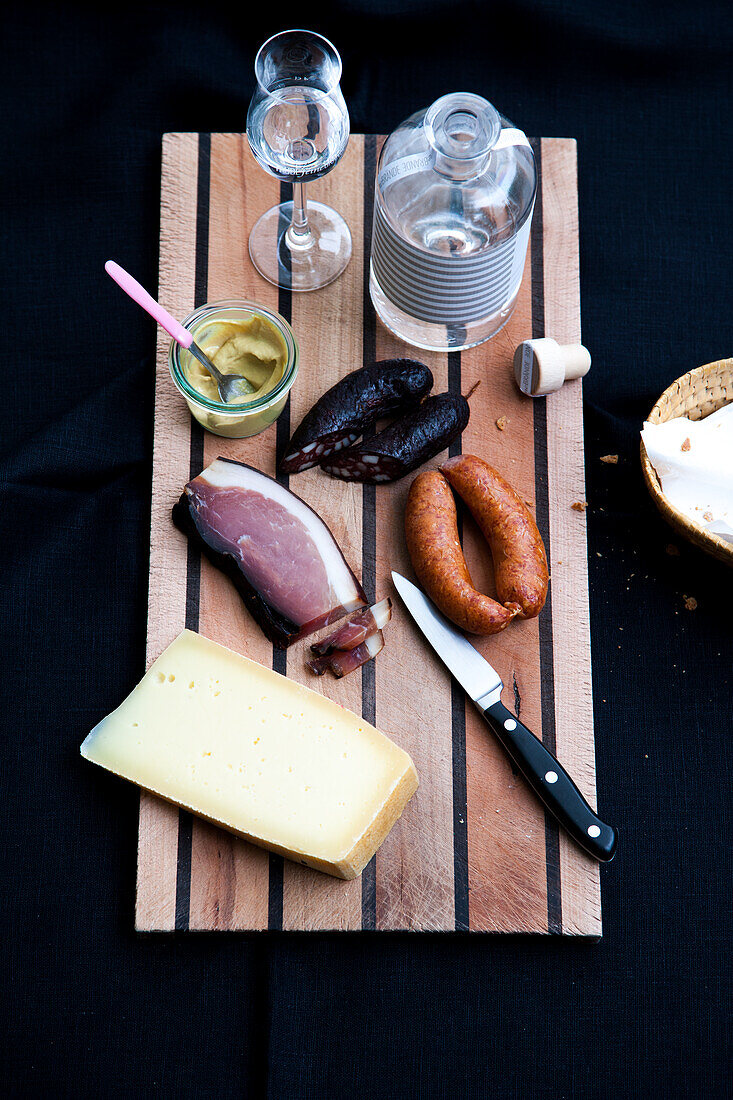 Brotzeit with mountain cheese, bacon, sausage, and cherry brandy