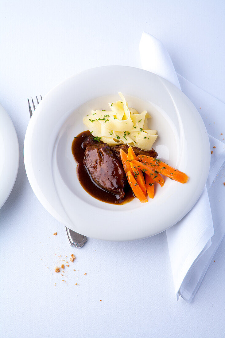 Braised pheasant with ribbon noodles and carrots