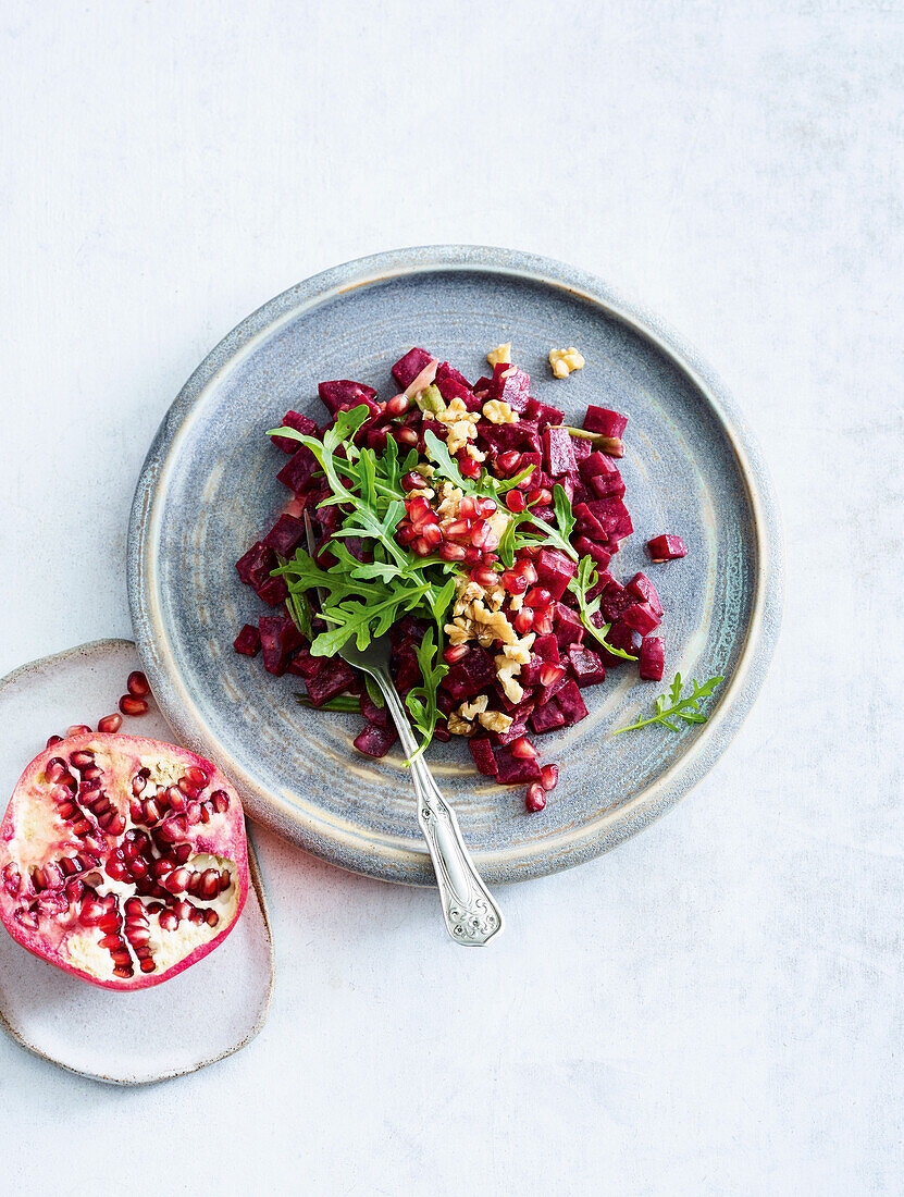 Vegan beetroot salad with walnuts and pomegranate seeds