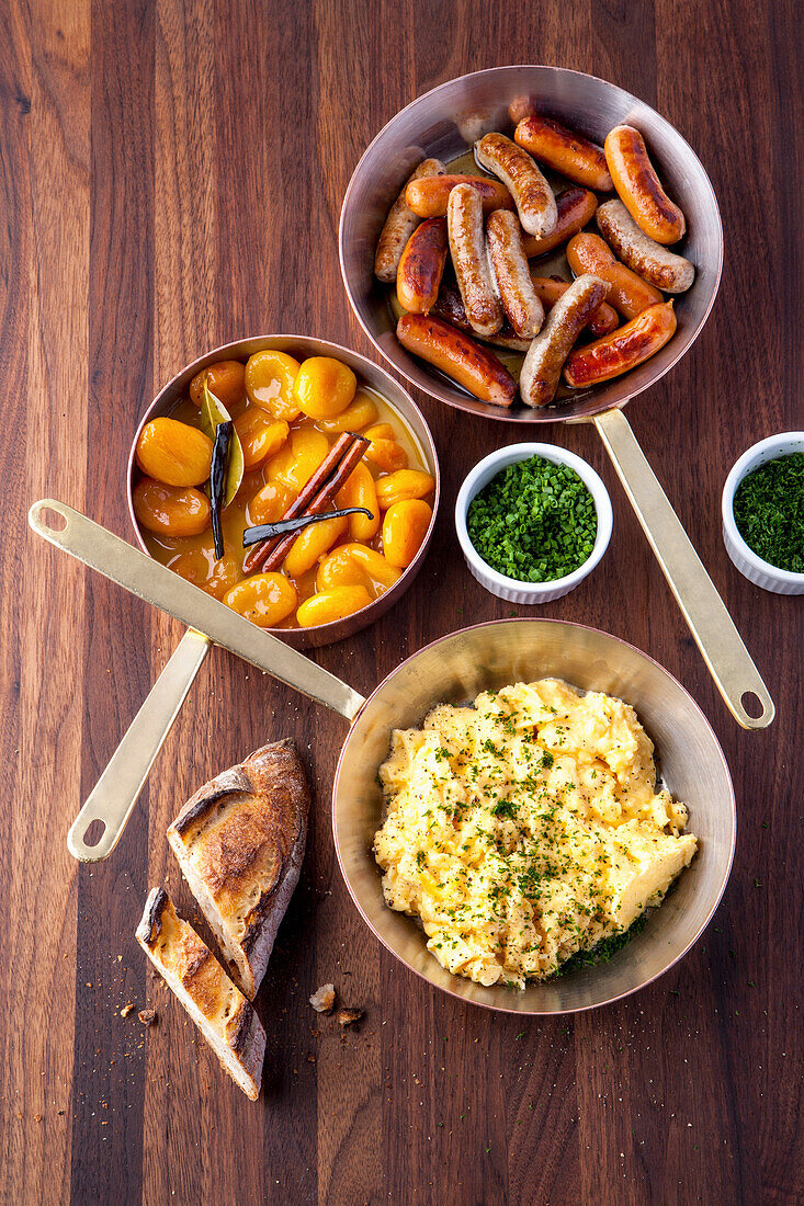 Sausages, scrambled eggs and pickled apricots