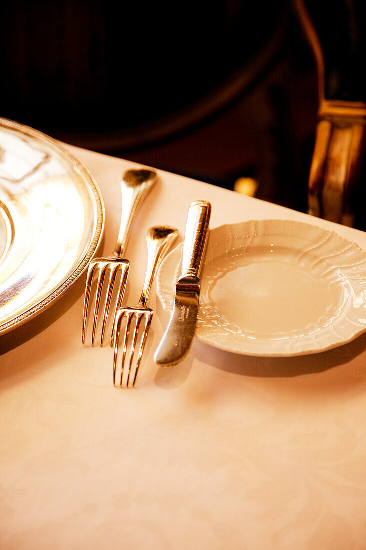 Place setting with silver cutlery in the restaurant
