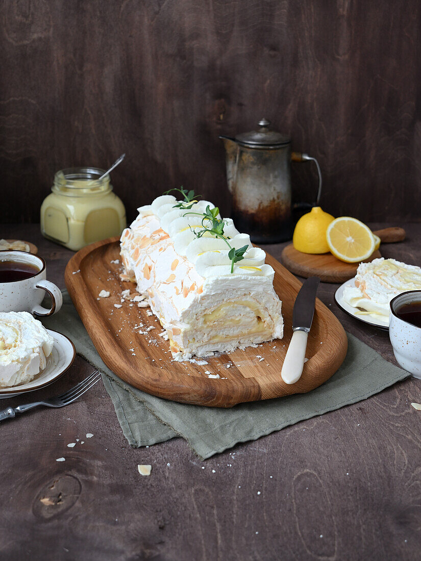 Meringue roll with lemon curd, cream cheese, and almonds