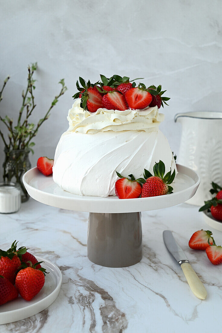 Pavlova with fresh strawberries and vanilla frosting