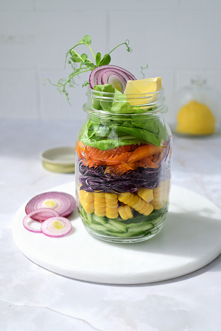 Vegetable salad with cucumber, corn, red cabbage, bell peppers, and lettuce
