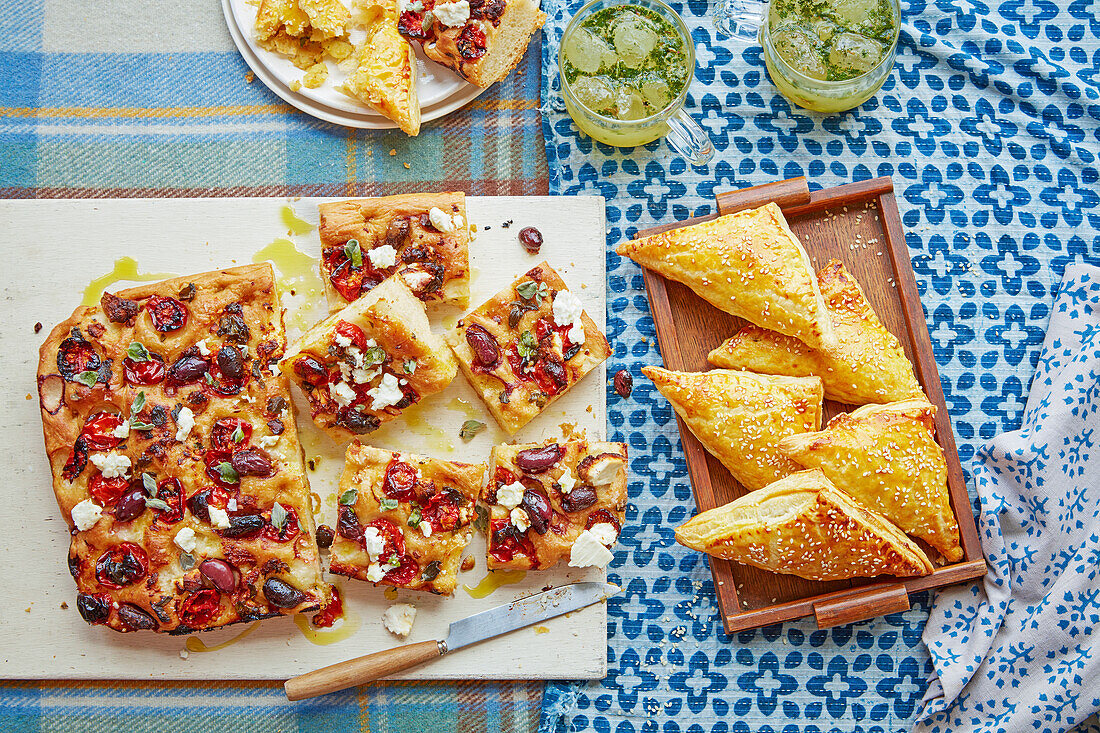 Focaccia with olives, cherry tomatoes and feta, masala potato puffs and jal jeera