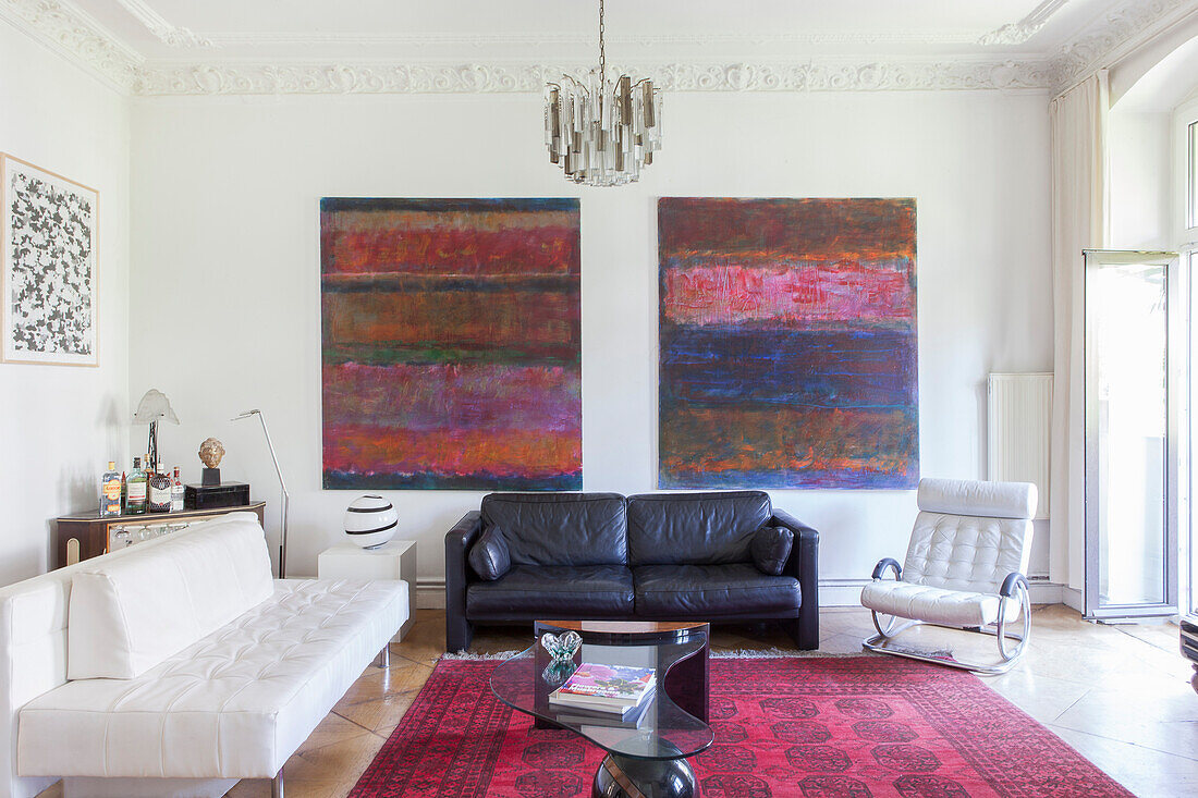 Seating in black and white, modern art on the wall in the old-style living room