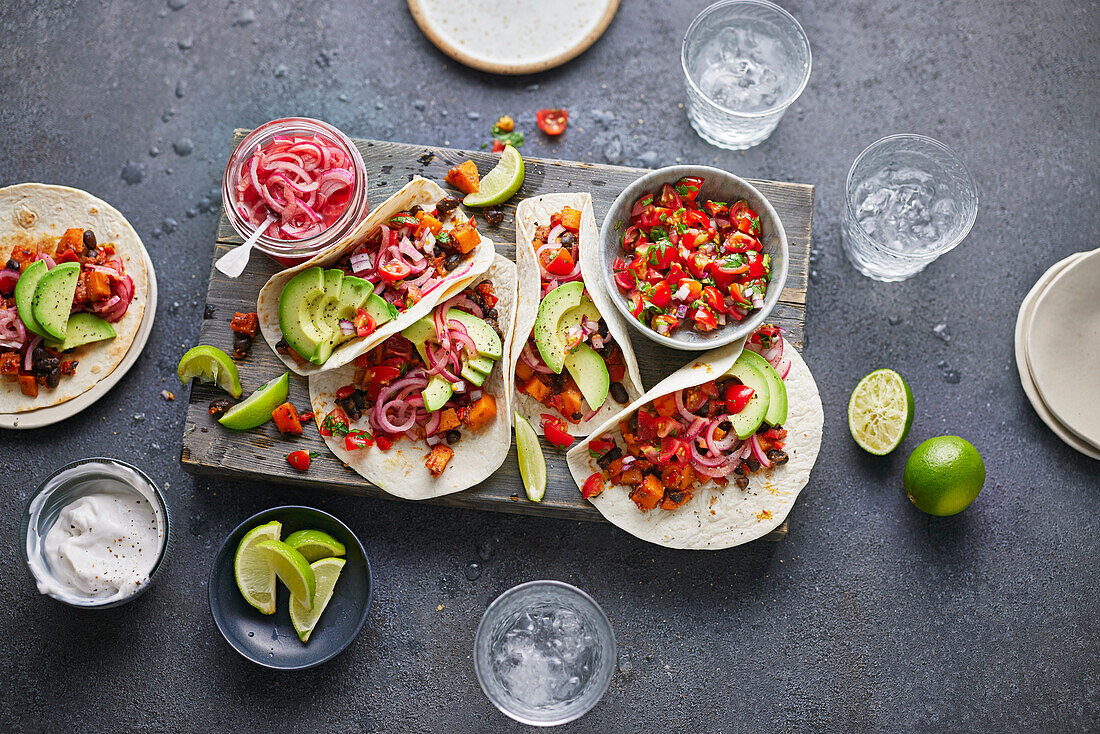 Vegan tacos with tomato salsa, avocado, and pickled onions