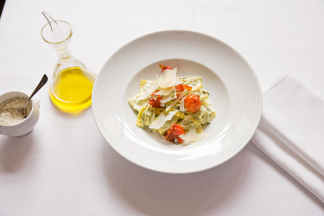 Herb ravioli with Parmesan curls