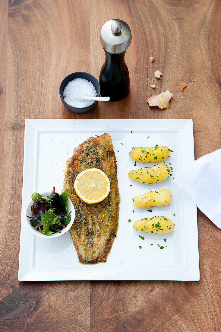 Fried sole with boiled potatoes and wild herb salad