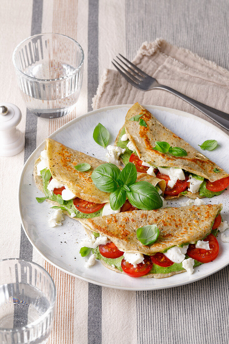 Hearty pancakes with tomatoes and pesto