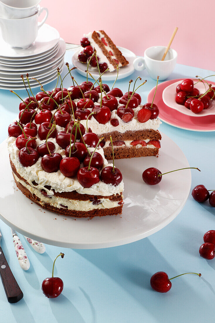 Chocolate cake with cherries and cream