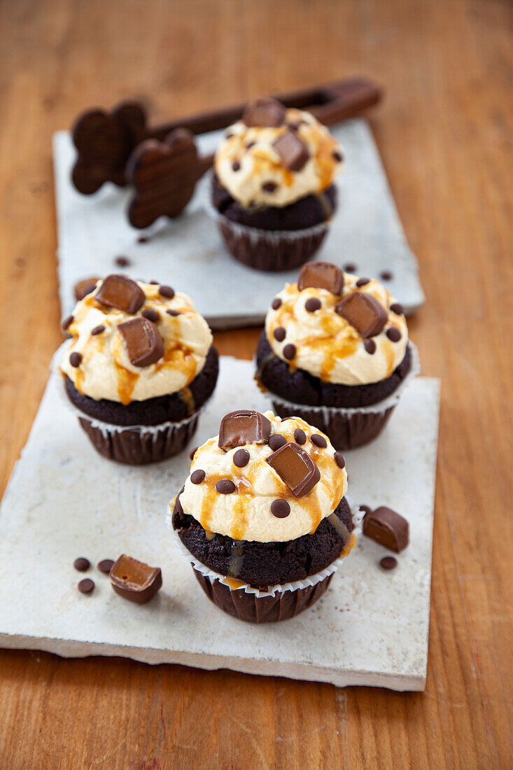 Chocolate cupcakes with caramel topping and toffee pralines