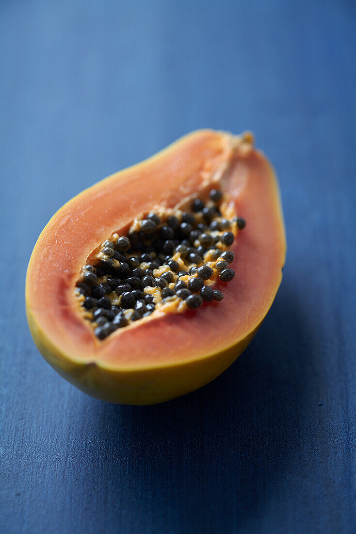 Papaya half on a blue background