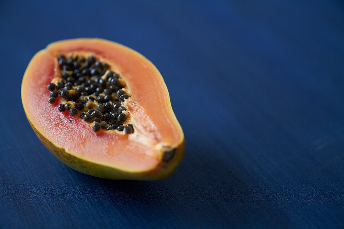Papaya half on a blue background