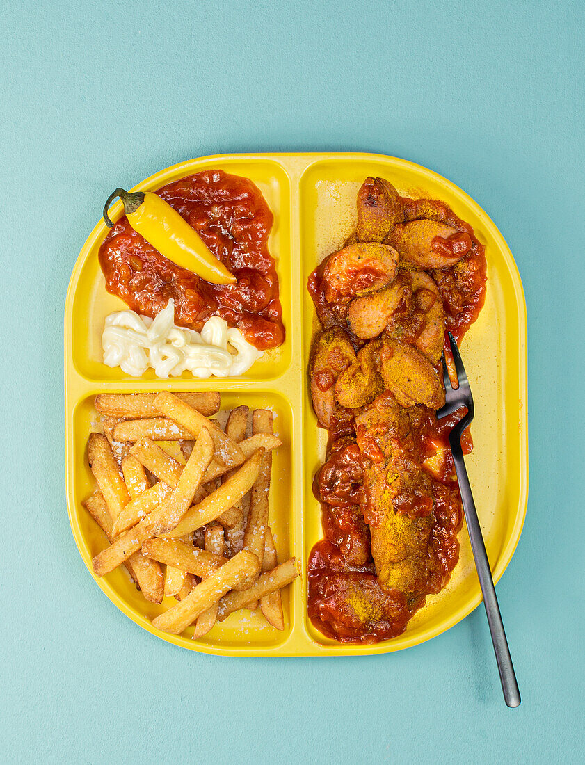 Vegan curry sausage substitute with chips and mayo