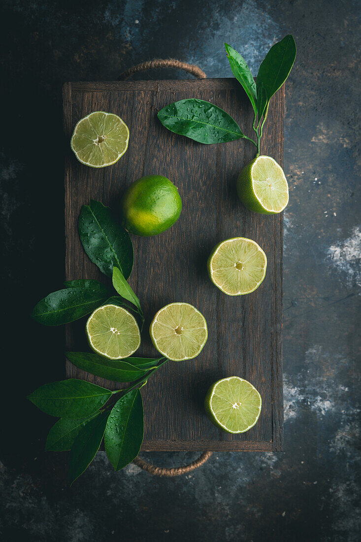 Limes with leaves on a dark background