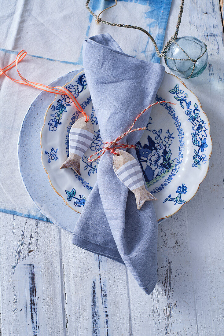 Blue and white place setting with maritime table decoration