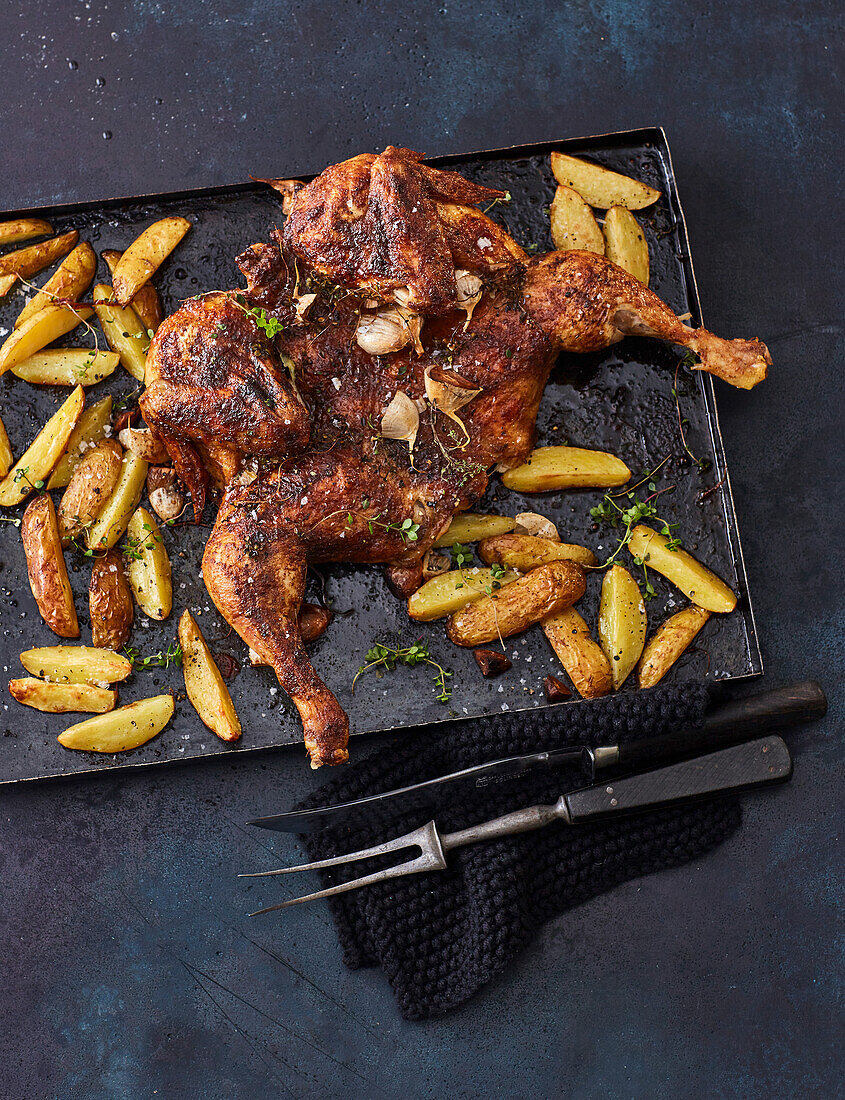 Roast spatchcock chicken with potato wedges