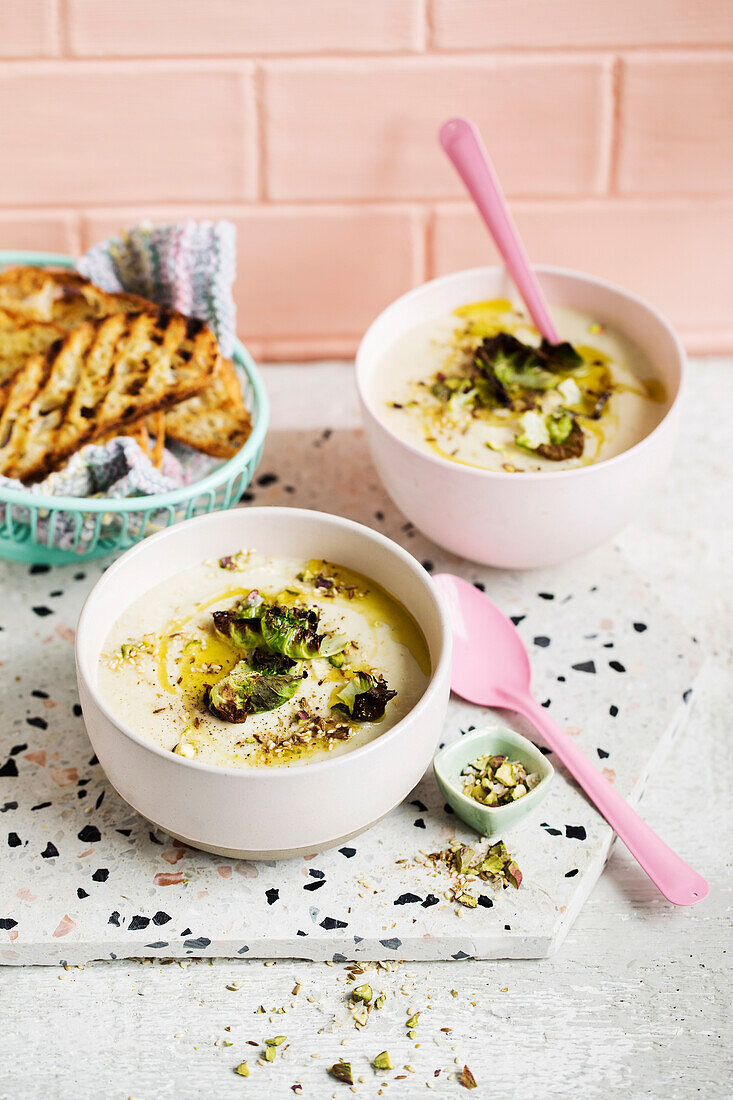 Cauliflower and leek soup with crisp sprout leaves