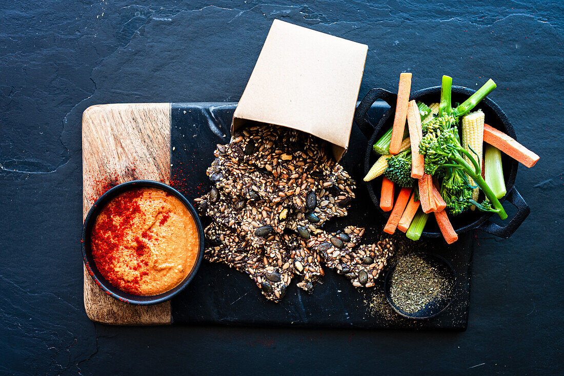 Seed crackers with red pepper hummus