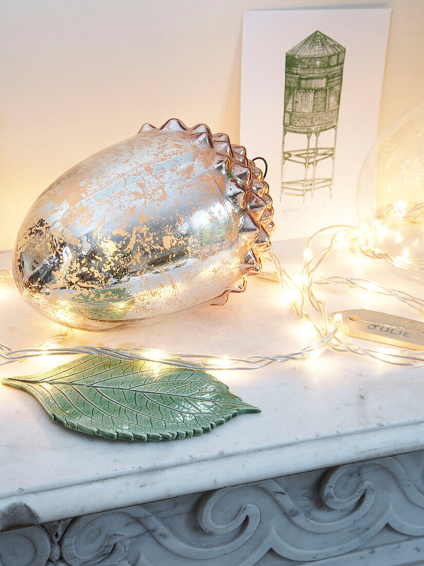 Lighting and ornament on a mantelpiece