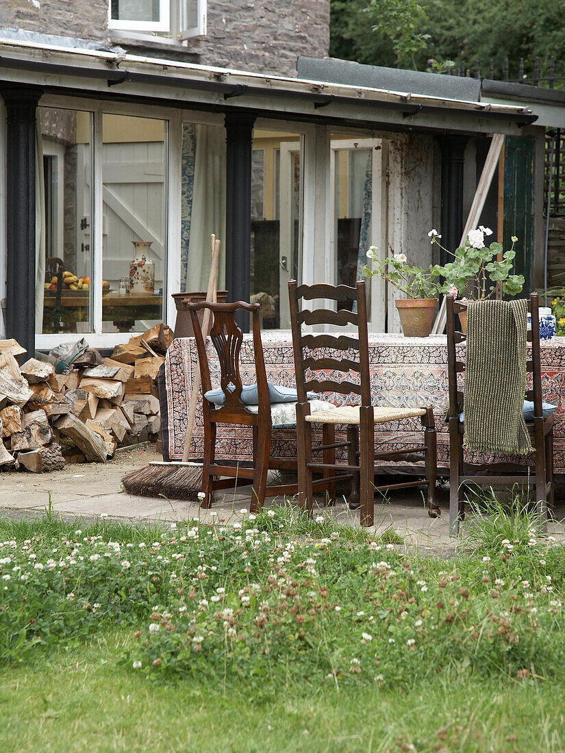 Exterior and back garden of a period home with table and chairs