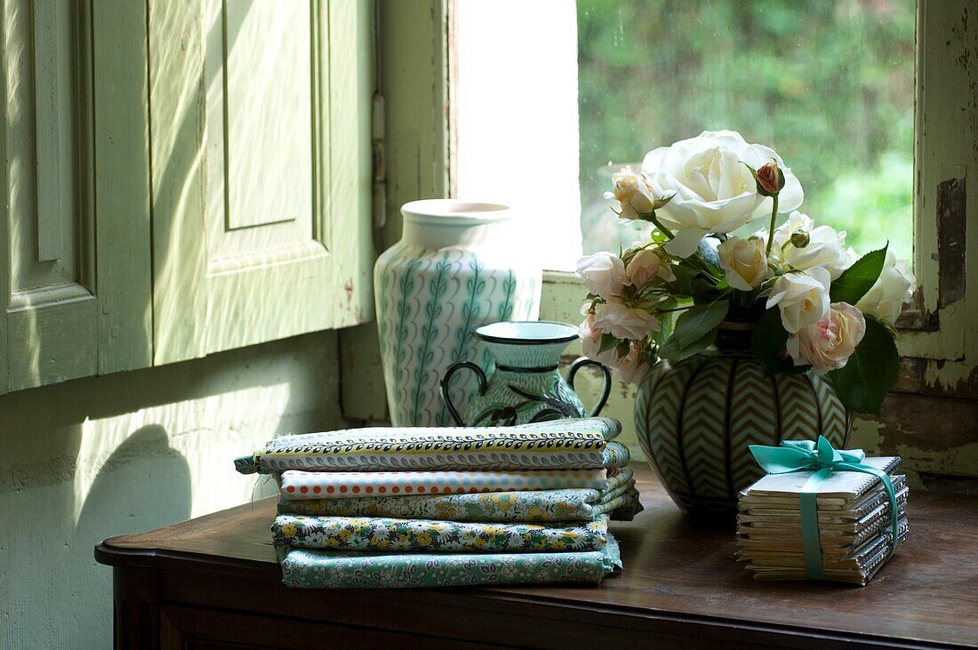 Still life with flowers and folded tablecloth