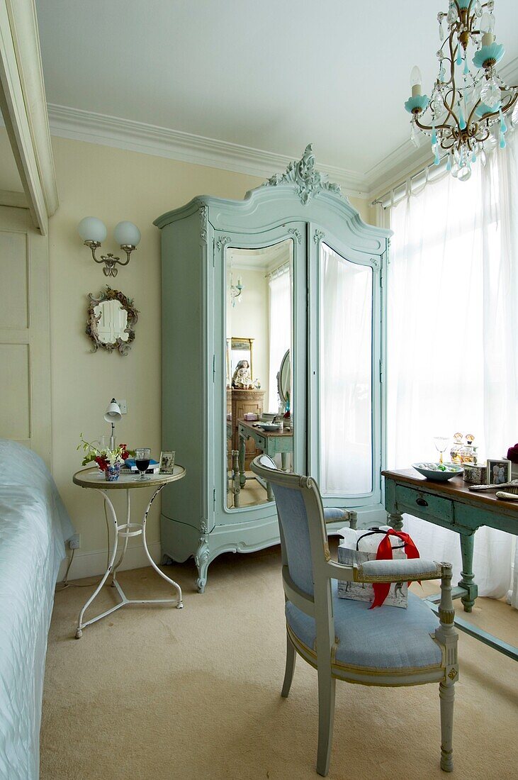 Bedroom with closet with mirror armchair and night table