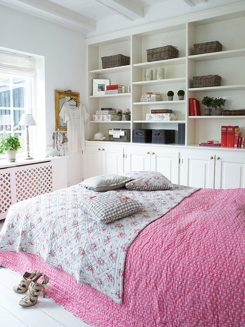 bedroom with pink bedspread