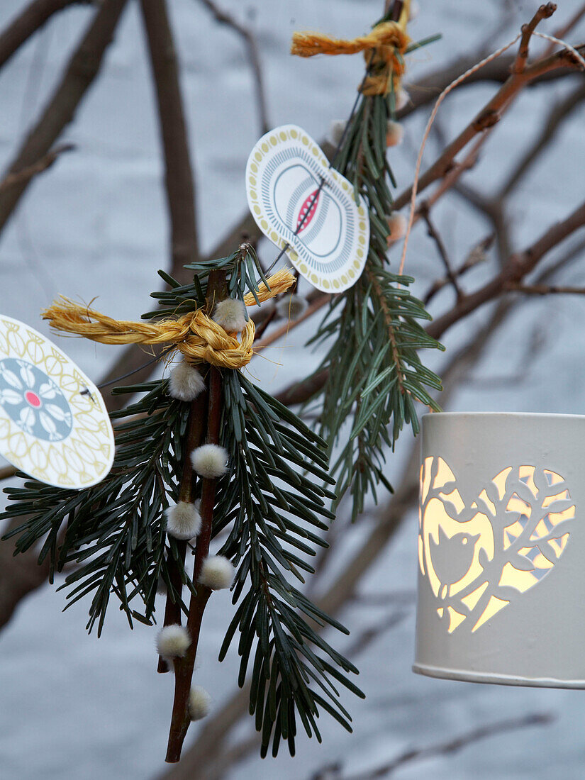 Christmas tree decorations and lit tealight in Herefordshire cottage, England, UK