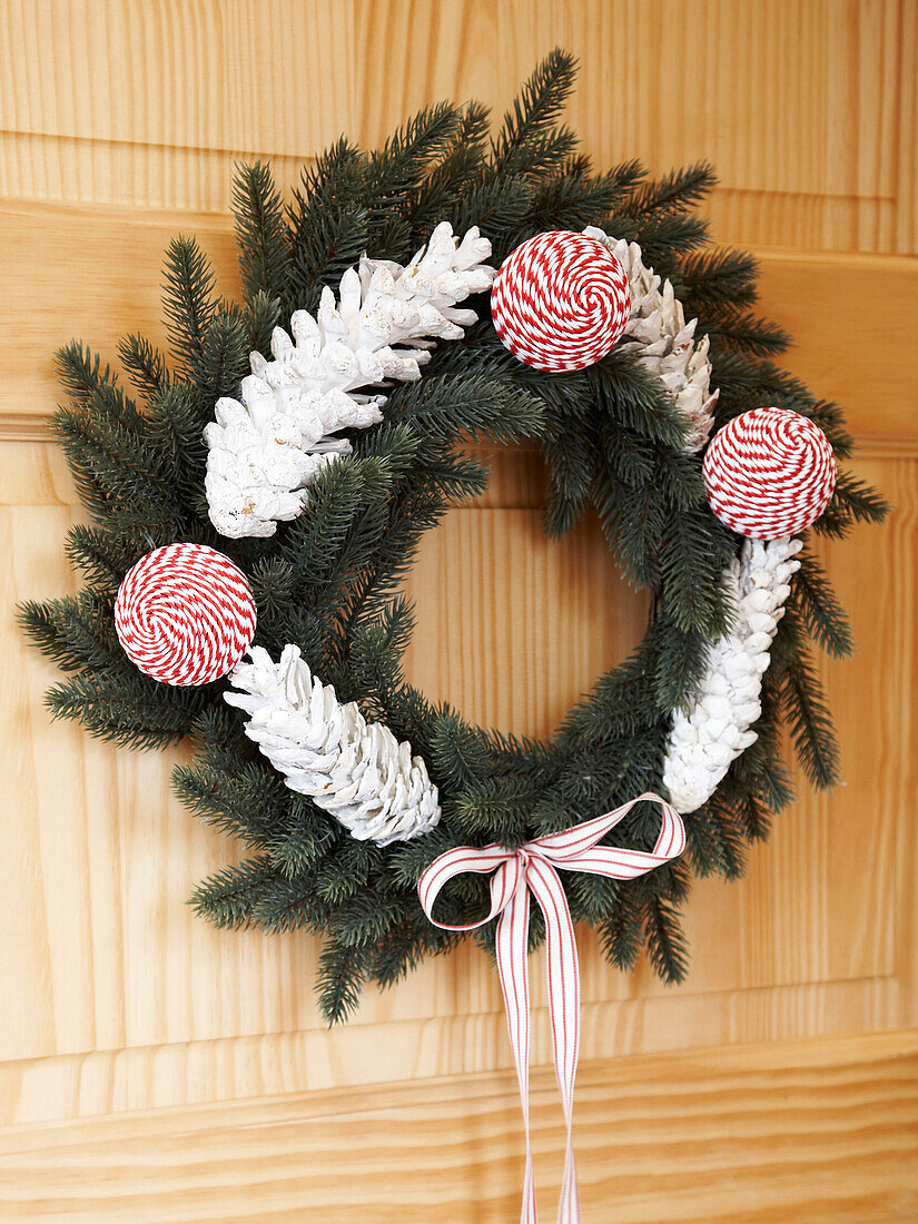 Contemporary floral wreath on wooden front door, Poland