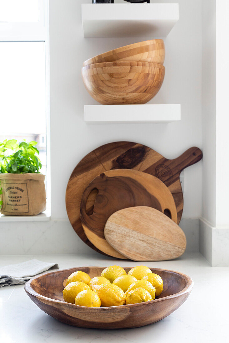 Chopping boards and bowls with lemons in Reigate kitchen, Surrey, UK