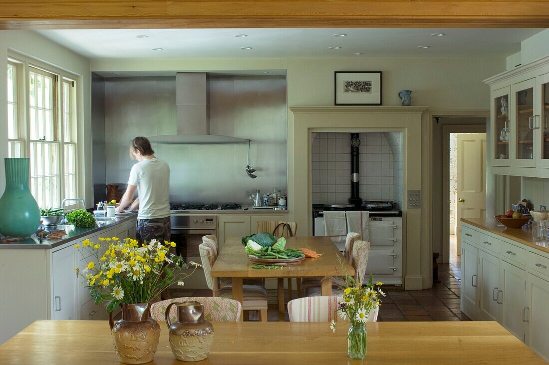 Young man preparing food in rustic kitchen