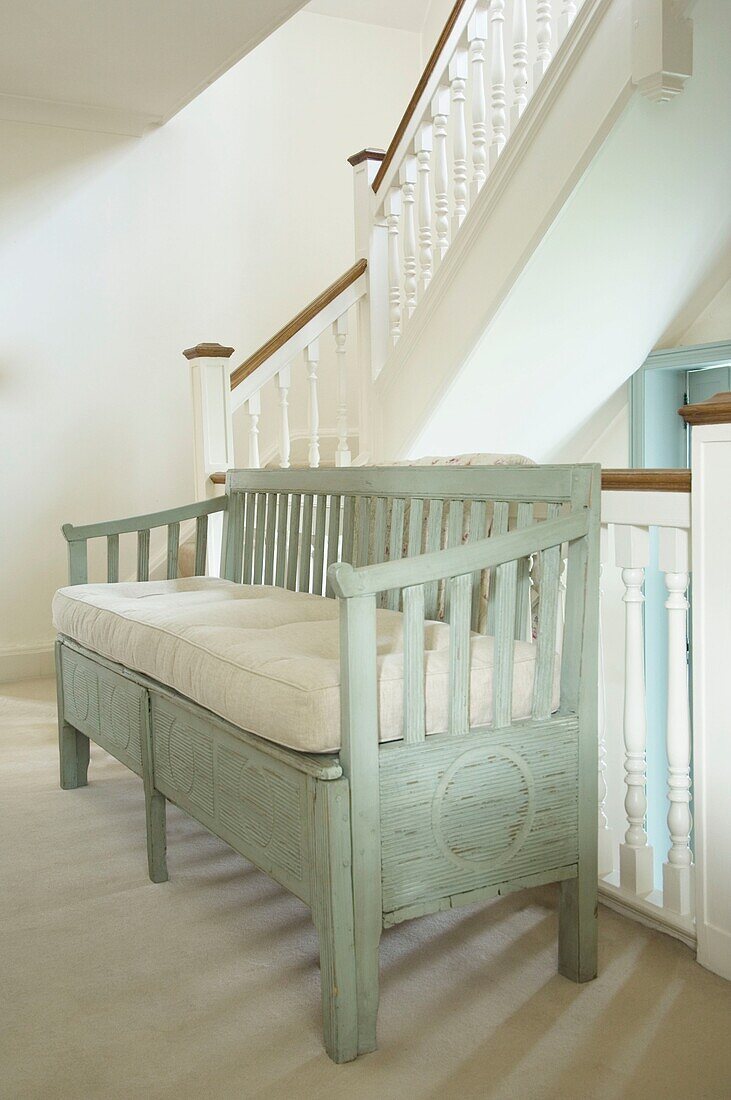 Wooden rustic sofa in staircase