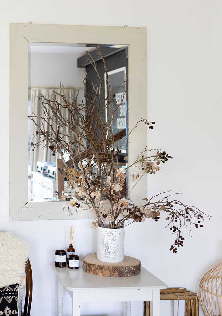 Dried flowers on log disc with mirror and organic natural soy wax candles in Colchester home Essex UK