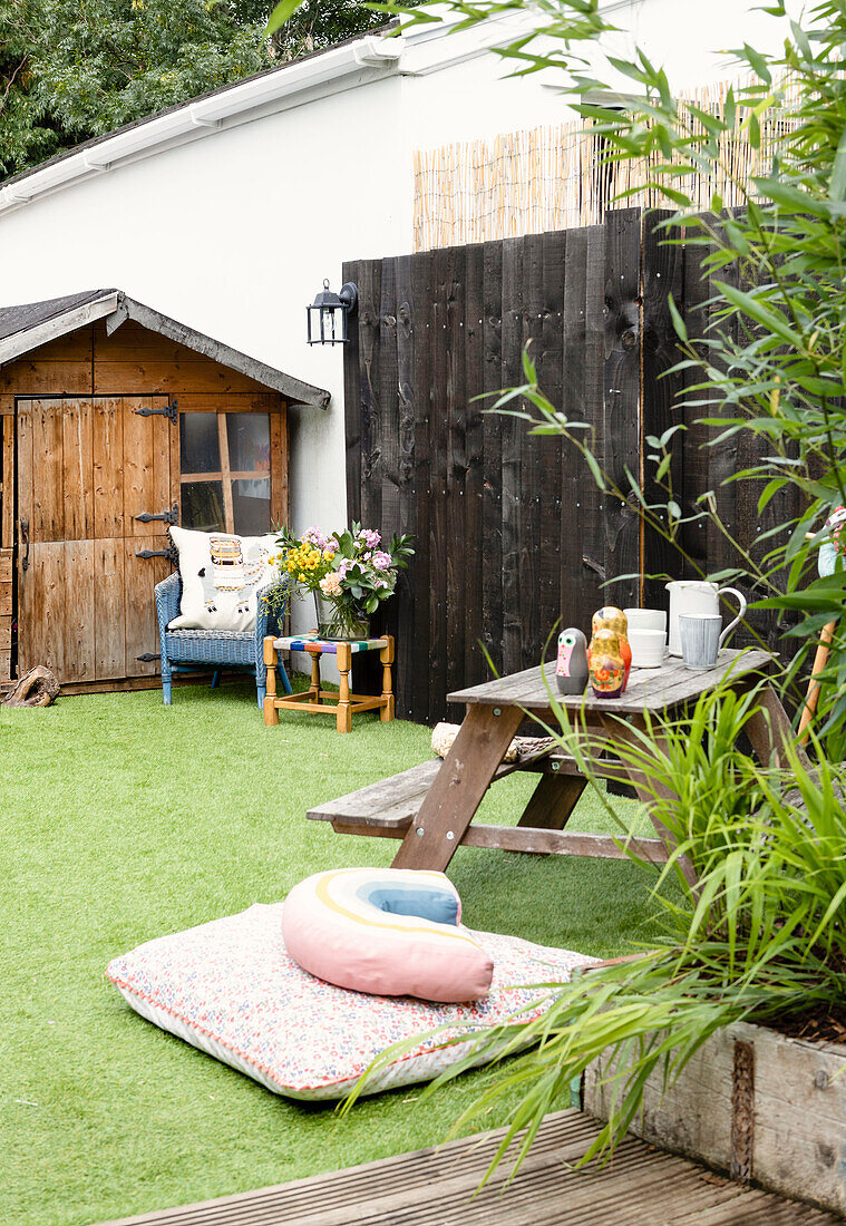 Picnic table and shed in garden with astro turf lawn, Cardiff, Wales, UK