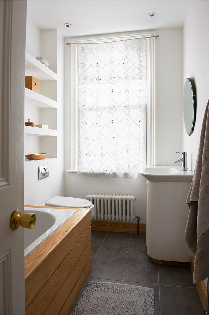 Net curtains in bathroom window of Broadstairs home, Kent, England, UK