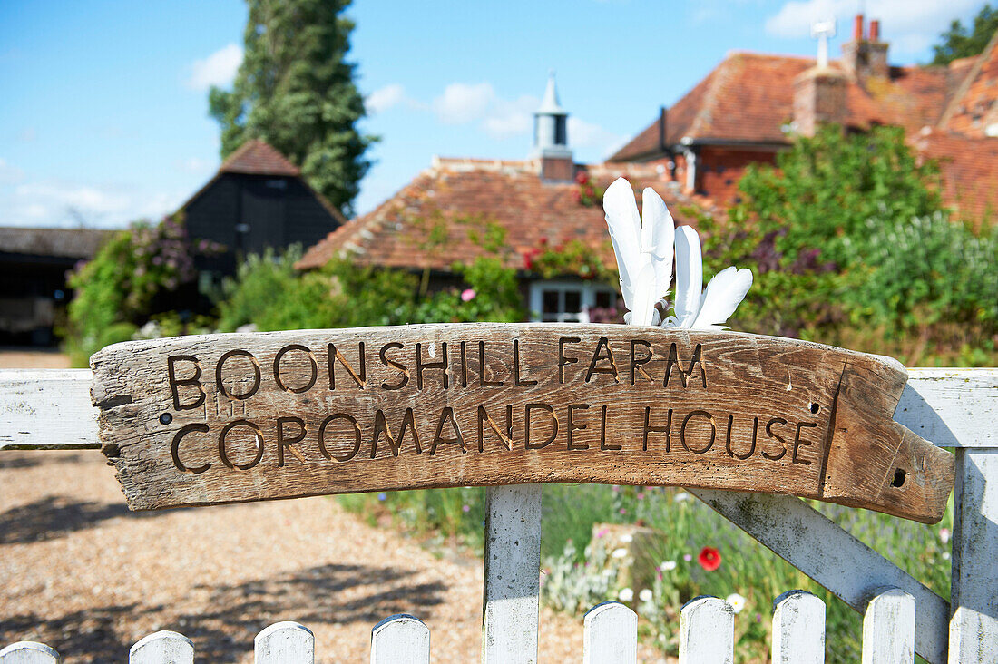 Signpost on gate to farmhouse in Iden, Rye, East Sussex, UK