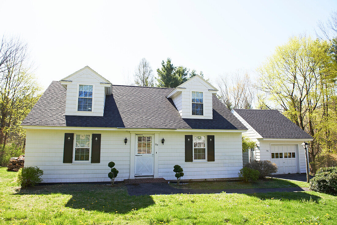 White facade of detached home with dormer windows in the Berkshires, Massachusetts, Connecticut, USA