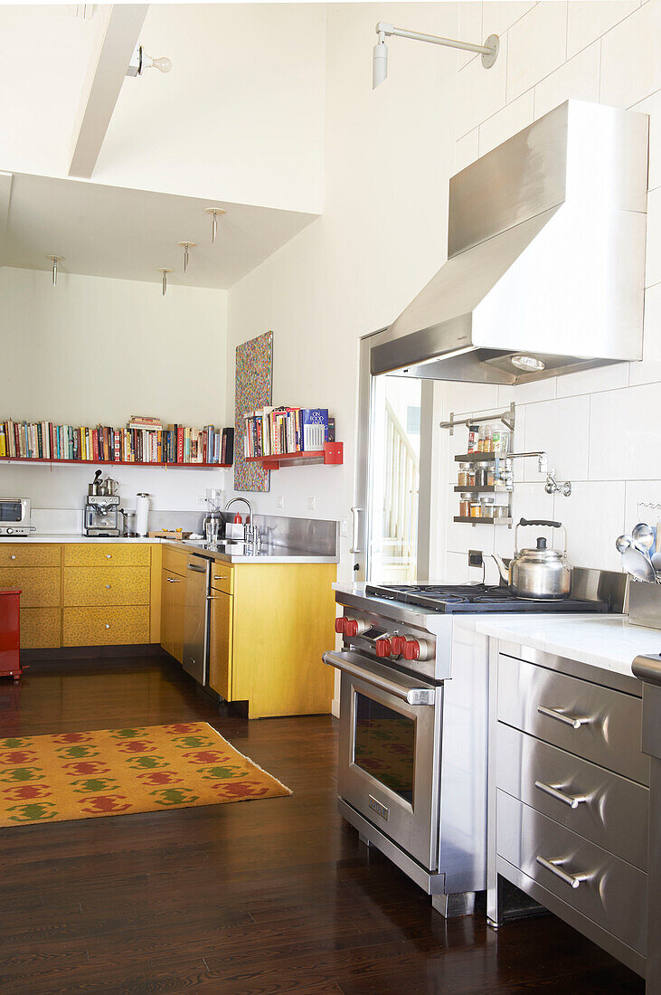 Stainless steel oven in open plan yellow fitted kitchen of Sheffield home, Berkshire County, Massachusetts, United States