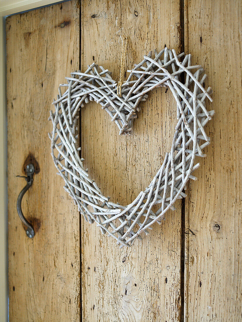 Hand crafted heart shape on wooden door in Gloucestershire farmhouse, England, UK